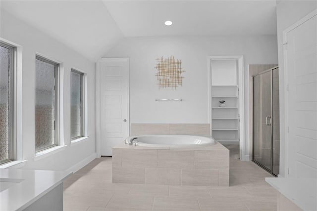 bathroom with tile patterned flooring, vanity, lofted ceiling, and independent shower and bath