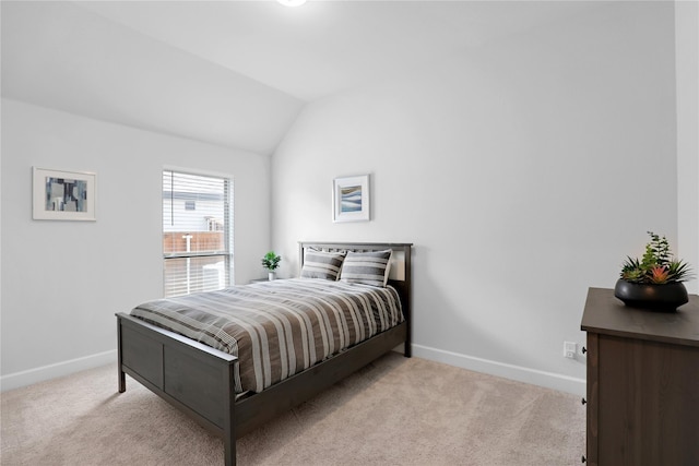 bedroom with light carpet and vaulted ceiling