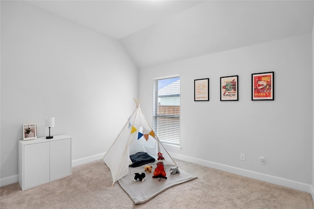 recreation room with light carpet and vaulted ceiling