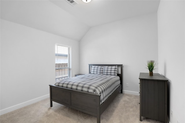 bedroom featuring light colored carpet and lofted ceiling