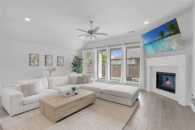 living room with ceiling fan and lofted ceiling