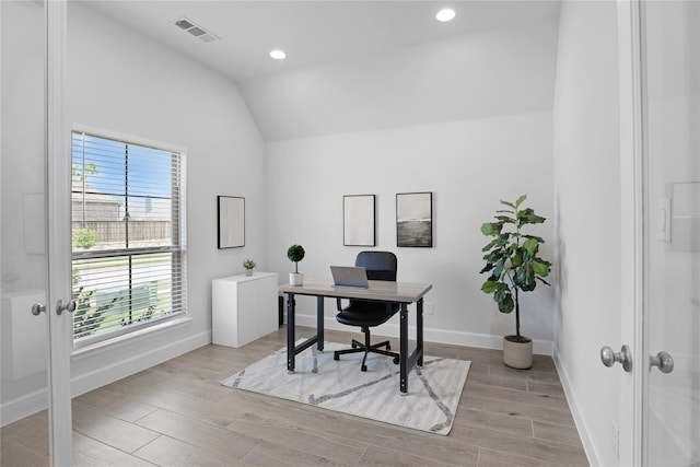 home office with french doors and lofted ceiling