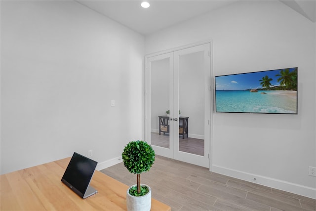 office featuring french doors and light hardwood / wood-style flooring