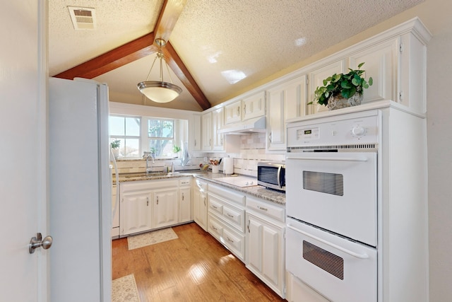 kitchen featuring white cabinetry, sink, white appliances, and premium range hood