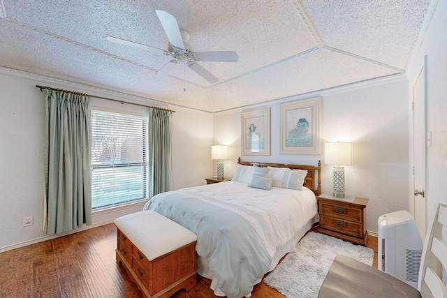 bedroom featuring a textured ceiling, vaulted ceiling, ceiling fan, and crown molding