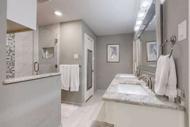 bathroom with vanity and a shower with shower door