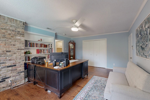 office area with ceiling fan, light wood-type flooring, and a textured ceiling