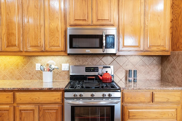 20175 Willow Glade Cir, Pilot Point, TX 76258 - kitchen with appliances with stainless steel finishes, decorative backsplash, light stone countertops, and brown cabinetry