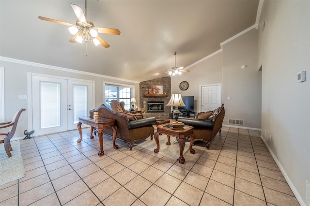 living area featuring ceiling fan, light tile patterned flooring, vaulted ceiling, crown molding, and a fireplace
