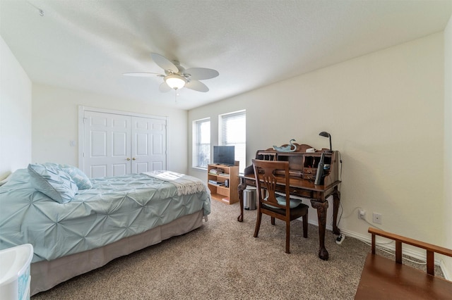 carpeted bedroom with ceiling fan and a closet