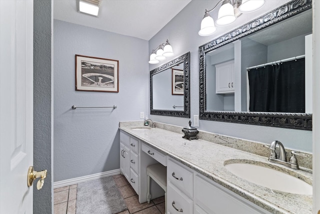 full bathroom featuring double vanity, baseboards, and tile patterned floors