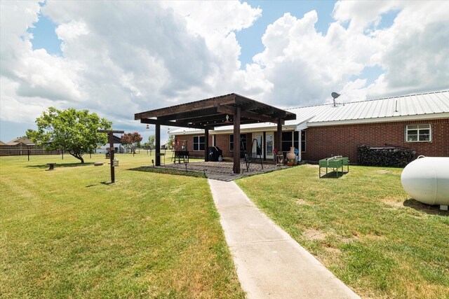 back of house featuring a pergola, brick siding, metal roof, and a patio area