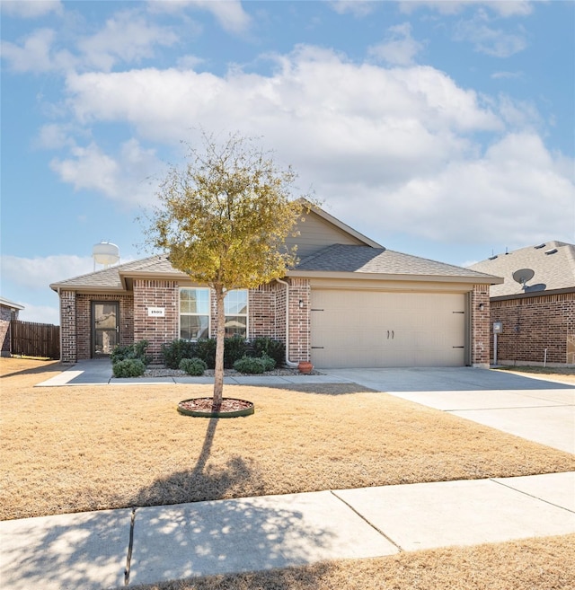 ranch-style home featuring a garage, concrete driveway, brick siding, and fence