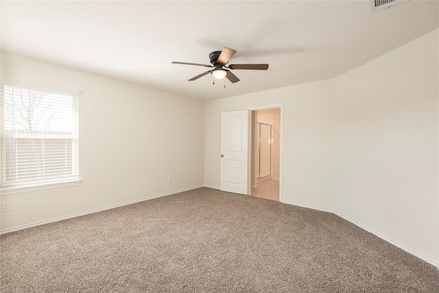 carpeted spare room featuring ceiling fan