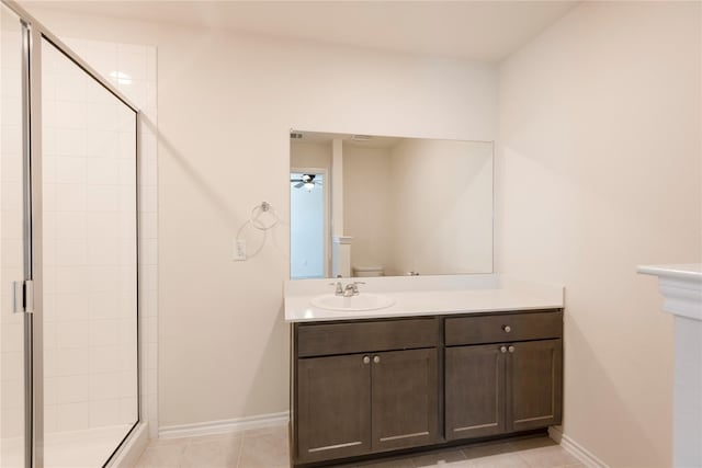 bathroom with vanity, tile patterned flooring, ceiling fan, toilet, and walk in shower