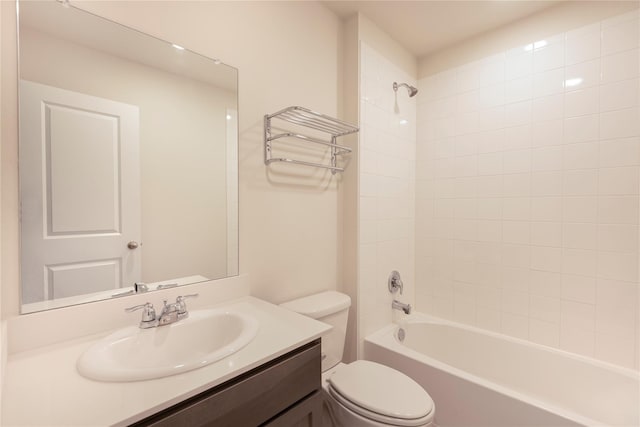 full bathroom featuring toilet, vanity, and tiled shower / bath