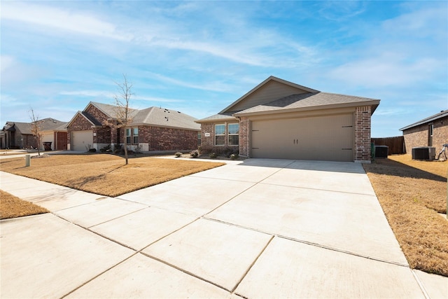 single story home with cooling unit, a garage, and a front yard