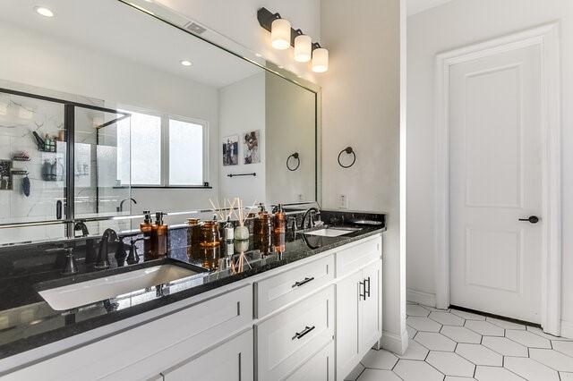 bathroom with vanity, tile patterned floors, and a shower with shower door