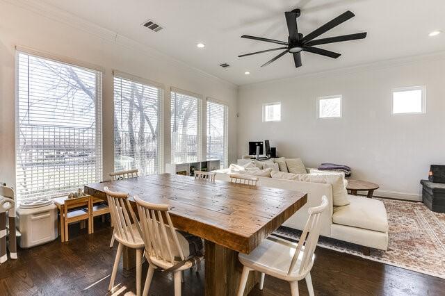 dining area with a healthy amount of sunlight, dark hardwood / wood-style flooring, ceiling fan, and ornamental molding