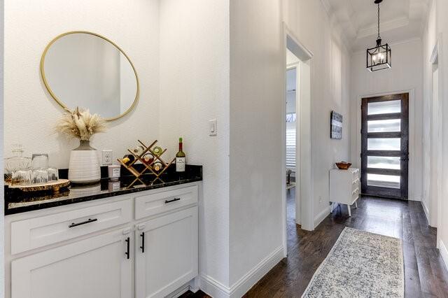 entrance foyer with dark hardwood / wood-style floors and ornamental molding