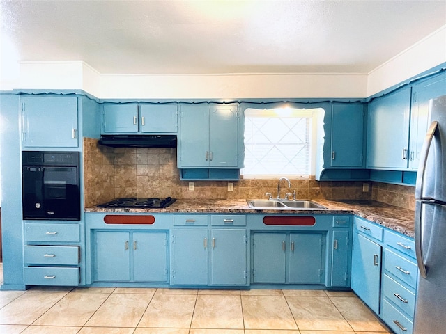 kitchen with sink, light tile patterned floors, black appliances, blue cabinets, and decorative backsplash