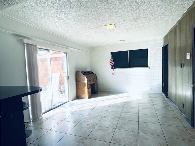 tiled empty room featuring wooden walls