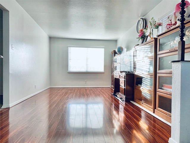 living room with dark wood-type flooring and a textured ceiling