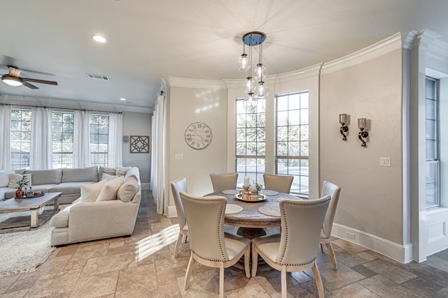 dining space with ornamental molding and ceiling fan with notable chandelier