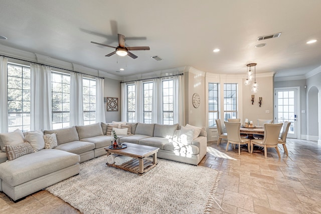 living room with crown molding and ceiling fan