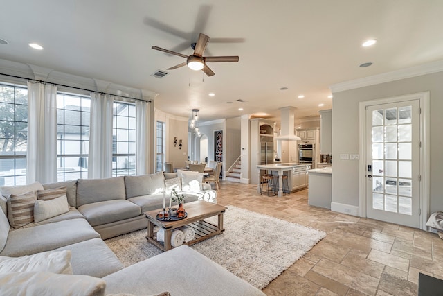 living room featuring crown molding and ceiling fan