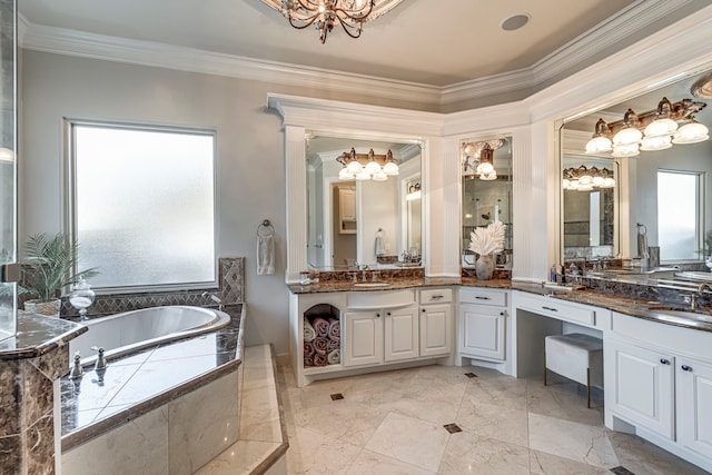 bathroom featuring crown molding, vanity, a chandelier, and tiled tub