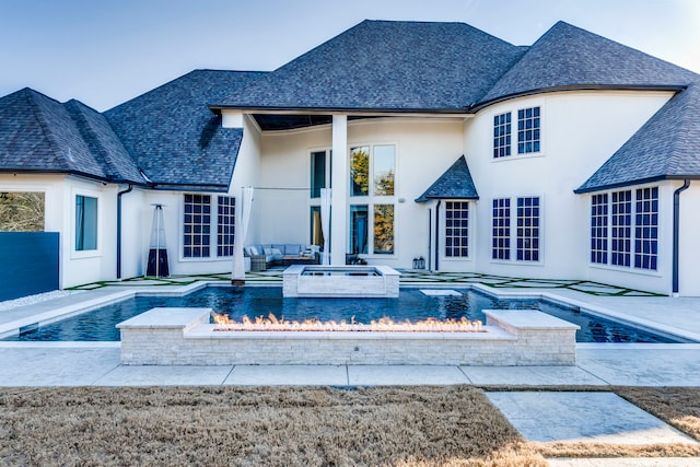 back of house with outdoor lounge area, a pool with hot tub, and a patio area