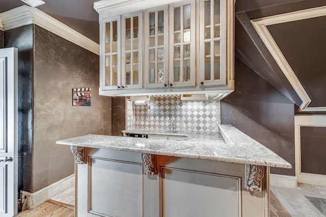 kitchen with light stone counters and tasteful backsplash