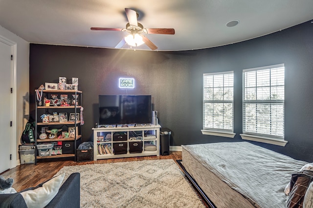 bedroom with ceiling fan and hardwood / wood-style floors