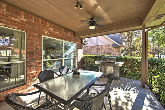 view of patio with area for grilling and ceiling fan