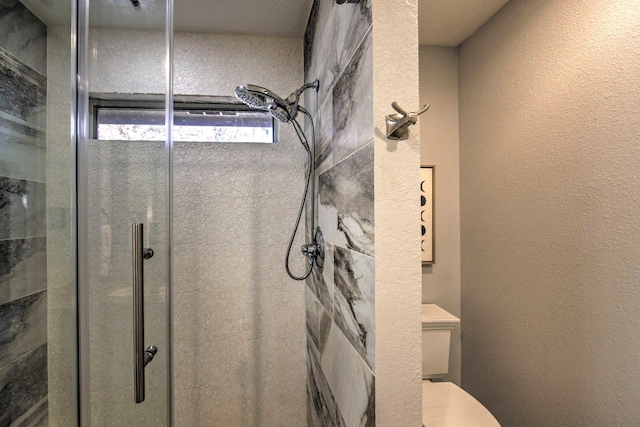 bathroom with toilet and walk in shower