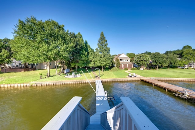 dock area featuring a water view and a lawn