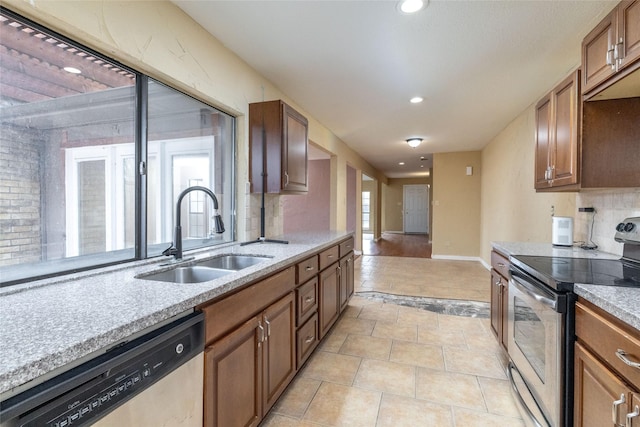 kitchen featuring light tile patterned floors, stainless steel appliances, tasteful backsplash, and sink