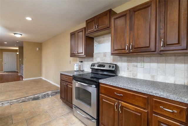 kitchen with decorative backsplash and electric stove