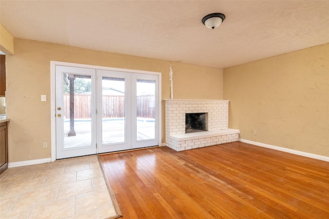 unfurnished living room featuring a brick fireplace