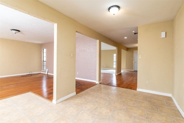 spare room featuring light tile patterned floors and plenty of natural light