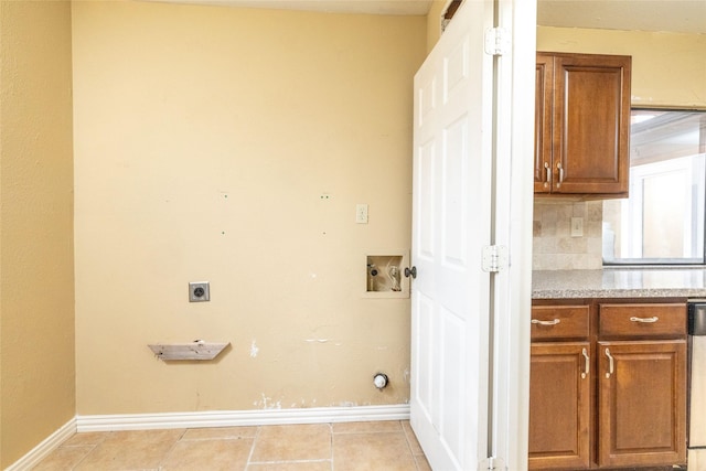 laundry area featuring electric dryer hookup, light tile patterned floors, and washer hookup