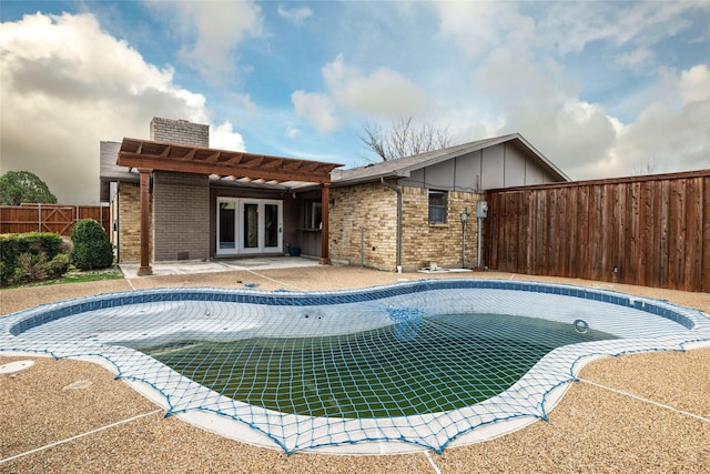 view of pool with french doors, a pergola, and a patio