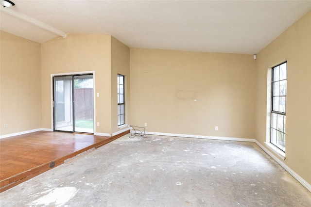 spare room with vaulted ceiling with beams