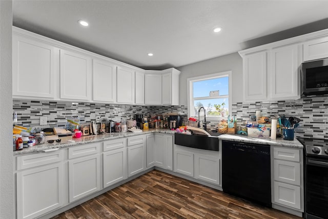 kitchen featuring white cabinets and black appliances