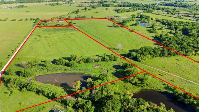 birds eye view of property featuring a water view and a rural view