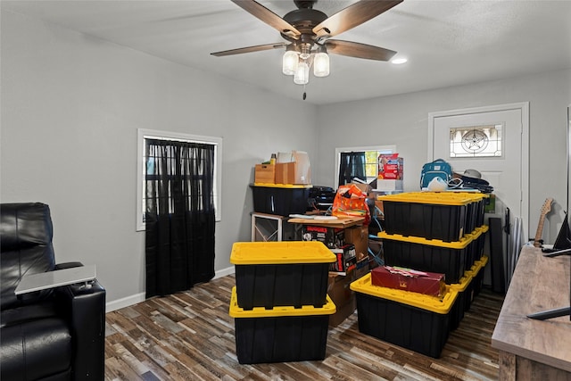 game room with dark hardwood / wood-style flooring and ceiling fan