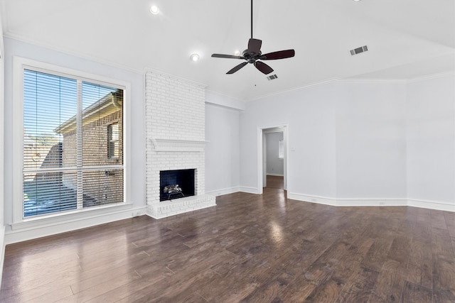 unfurnished living room with a brick fireplace, ceiling fan, crown molding, and dark hardwood / wood-style floors