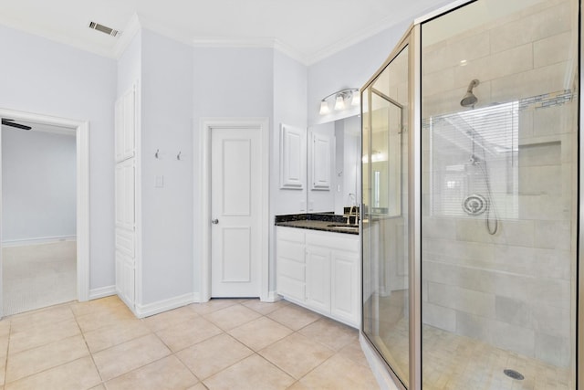 bathroom with vanity, tile patterned floors, crown molding, and an enclosed shower