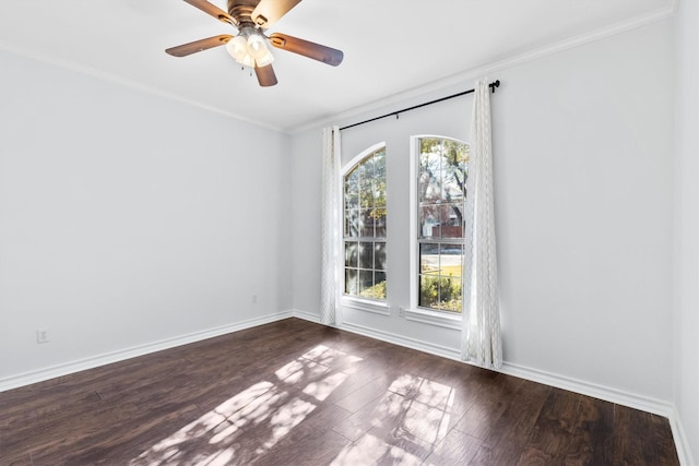 spare room with dark hardwood / wood-style flooring, ornamental molding, and ceiling fan